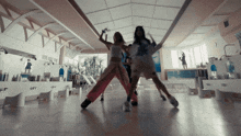 a group of women are dancing in a room that has a 65 degree temperature