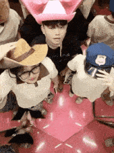 a group of people wearing cowboy hats and police hats are taking a selfie