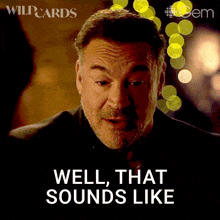 a man says well that sounds like in front of a blurred background