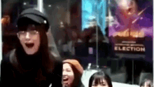 a group of people are laughing in front of a election poster