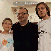 a man and two boys are posing for a picture with the words alight motion below them
