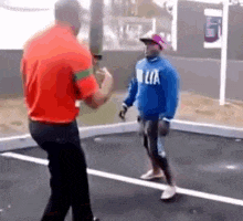 two men are standing next to each other on a sidewalk .