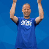 a man in a blue shirt is holding a sign that says exact