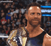 a man with a beard is holding a championship belt