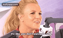 a woman is talking into a microphone and saying `` it 's like you don 't wanna be rude ''