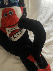 a stuffed monkey is wearing a shirt that says ' snuggle is real '