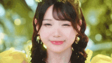 a close up of a woman wearing a yellow dress and pearl earrings