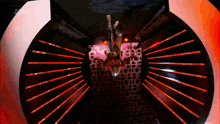 a woman is doing a handstand in a dark room with red lights