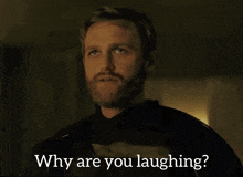 a man with a beard is laughing with the words why are you laughing below him