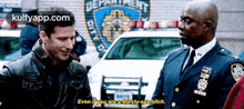 two police officers are talking to each other in front of a new york city police department car .