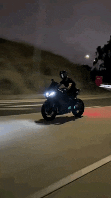 a person riding a motorcycle down a highway at night