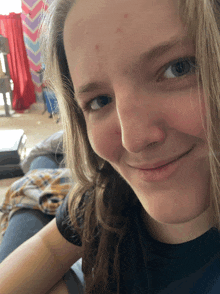 a girl with a bandage on her arm is smiling