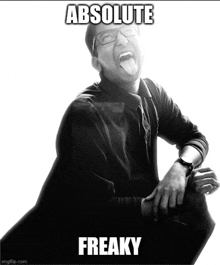 a black and white photo of a man with his tongue out and the words absolute freaky below him