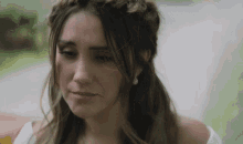 a woman with a braid in her hair is looking down