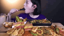 a woman is eating a variety of food with a spoon
