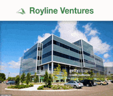 a picture of a royline ventures building with cars parked in front