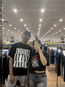 a man and a woman are taking a picture in a store