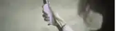 a person is holding a cell phone in their hand and looking at it .