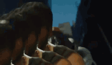 a man with a beard is giving the middle finger in a blurry photo .