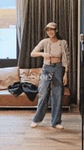 a woman is standing in front of a couch in a room .