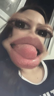 a close up of a woman making a face with her tongue out