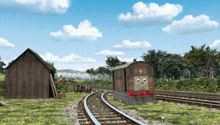 a train is going down the tracks in a field
