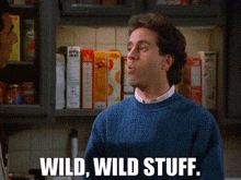 a man in a blue sweater is standing in front of a shelf with cereal boxes and says wild wild stuff .
