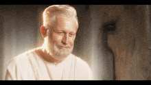 a man with a beard is wearing a white shirt