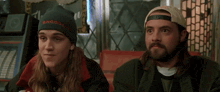 a man wearing a beanie that says snooze