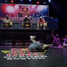 a man is laying on the floor in front of a sign that says red bull