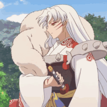a white haired anime character is holding a sword in his hand .