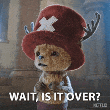 a stuffed animal wearing a hat with antlers and the words wait is it over