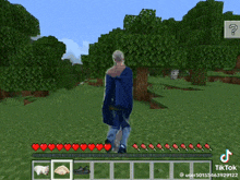 a man is walking in a video game called minecraft with hearts on the screen