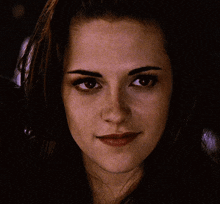 a close up of a woman 's face with a slight smile on her face