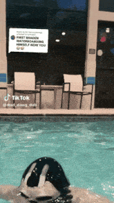 a person is swimming in a pool with a reply that says first braden waterboarding himself now you are