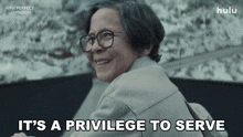 an advertisement for nine perfect strangers shows an elderly woman smiling and says it 's a privilege to serve
