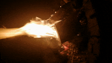 a fire is burning in a dark room with a lot of smoke