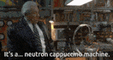 a man in a suit and tie stands in front of a machine that says it 's a neutron cappuccino machine