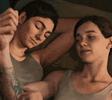 a man and a woman are laying next to each other on a bed .