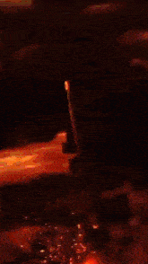 a painting of a person surrounded by flames in a dark room
