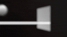 a blurred image of a white object with a black background