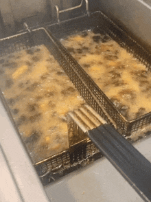 a fryer filled with fried food and a fork in it