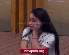 a woman sitting on a wooden deck with the website bbvipalb.org displayed