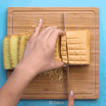 a person is cutting a loaf of bread on a cutting board with the words mr.cakes on the bottom