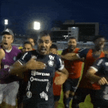 a group of soccer players with one wearing a blue jersey that says reinafarma