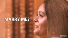a close up of a woman 's face with the words marry me behind her