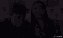 a man and a woman are sitting next to each other and the word mayward is on the bottom