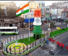 a clock tower with a flag flying in front of it