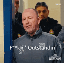 a man in a wrexham jacket says f * kin ' outstanding sp