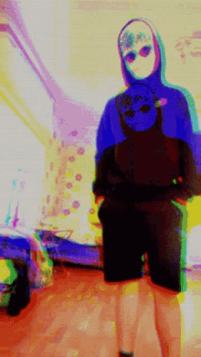 a blurry picture of a person wearing a hoodie with a skull on it